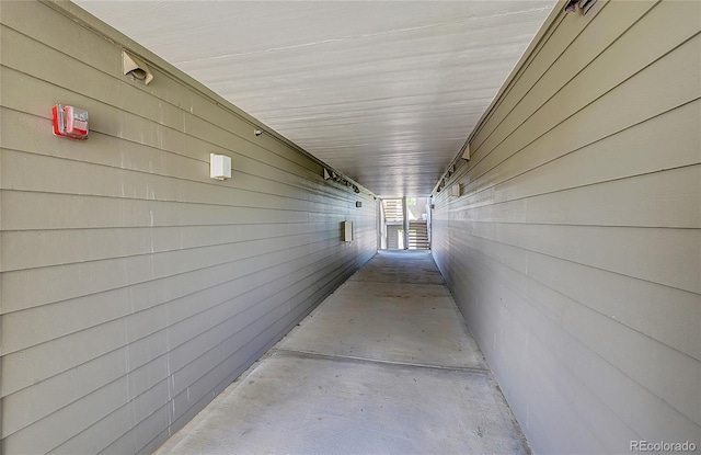 hall featuring wood walls