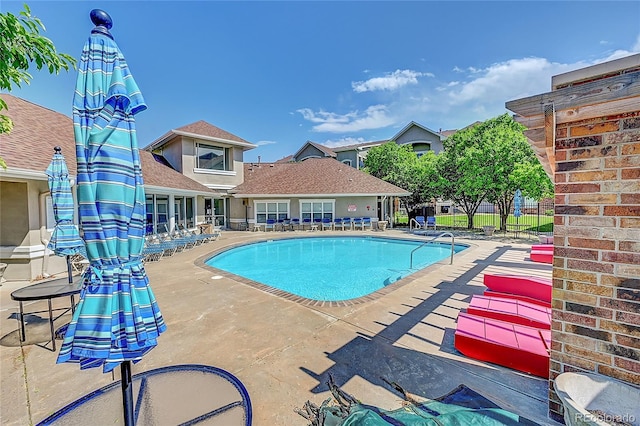 view of swimming pool featuring a patio area