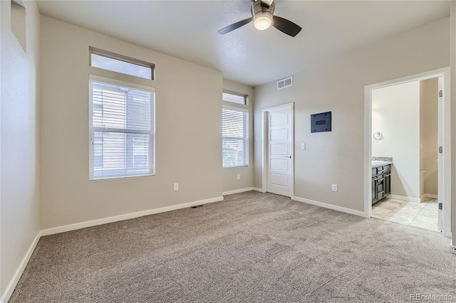 2564 Sweet Wind Ave, Castle Rock, CO 80109 - unfurnished bedroom featuring light colored carpet, baseboards, connected bathroom, and a ceiling fan