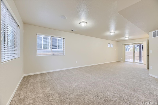 2564 Sweet Wind Ave, Castle Rock, CO 80109 - empty room featuring light carpet, baseboards, and a textured ceiling