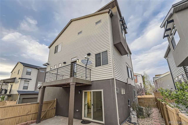 2564 Sweet Wind Ave, Castle Rock, CO 80109 - back of property with fence, a balcony, a patio, and stucco siding