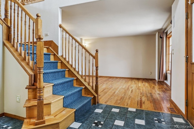 9920 Glenellen Dr, Peyton, CO 80831 - stairway featuring visible vents, baseboards, and wood finished floors
