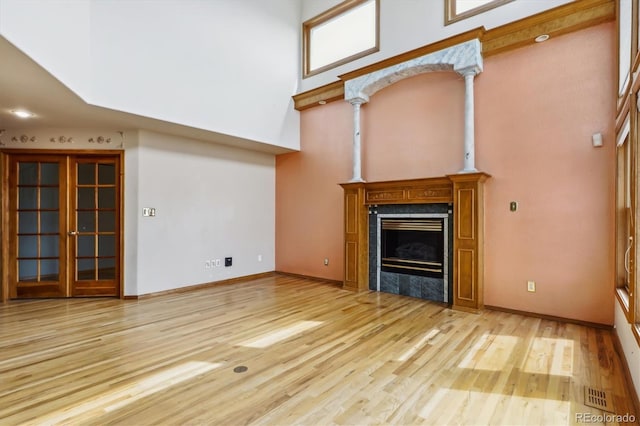 9920 Glenellen Dr, Peyton, CO 80831 - unfurnished living room featuring a fireplace, visible vents, baseboards, and wood finished floors