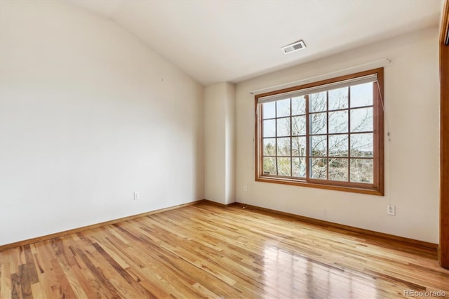 9920 Glenellen Dr, Peyton, CO 80831 - unfurnished room with light wood-style flooring, visible vents, baseboards, and vaulted ceiling