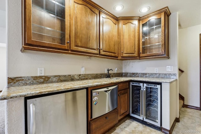 9920 Glenellen Dr, Peyton, CO 80831 - kitchen featuring brown cabinetry, freestanding refrigerator, beverage cooler, and glass insert cabinets