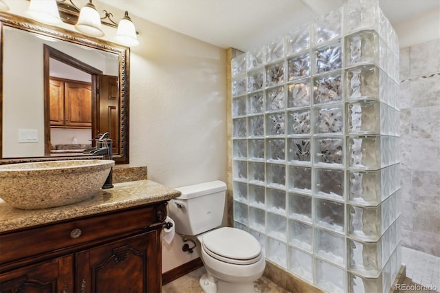 9920 Glenellen Dr, Peyton, CO 80831 - bathroom featuring a walk in shower, vanity, and toilet
