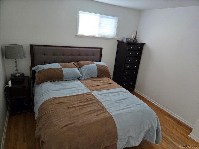 bedroom with hardwood / wood-style flooring