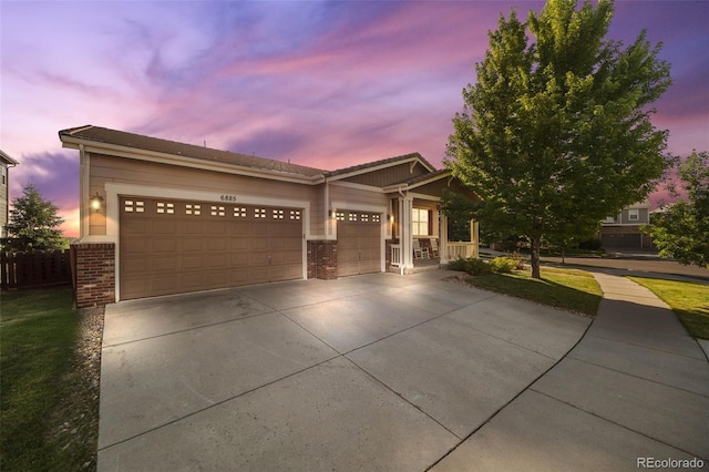 6885 S Buchanan Ct, Aurora, CO 80016 - view of front facade featuring brick siding, driveway, and a garage