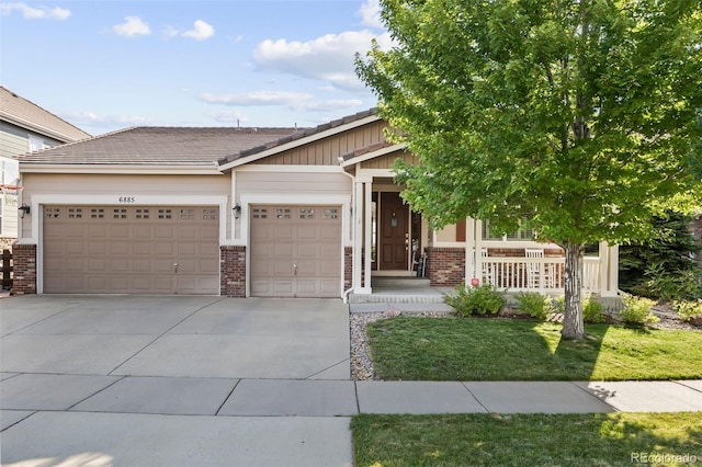 6885 S Buchanan Ct, Aurora, CO 80016 - craftsman-style house with brick siding, an attached garage, concrete driveway, and a porch