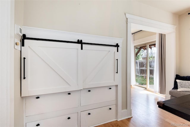 6192 S Pennsylvania St, Centennial, CO 80121 - detailed view of wood finished floors and a barn door