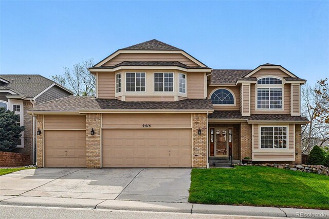 9515 Dolton Way, Highlands Ranch, CO 80126 - view of front facade featuring driveway, a front lawn, brick siding, and roof with shingles