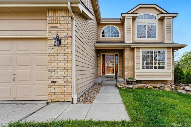 9515 Dolton Way, Highlands Ranch, CO 80126 - view of exterior entry featuring brick siding, a shingled roof, and an attached garage