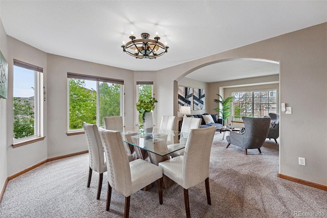 9515 Dolton Way, Highlands Ranch, CO 80126 - dining space with arched walkways, carpet flooring, baseboards, and healthy amount of natural light
