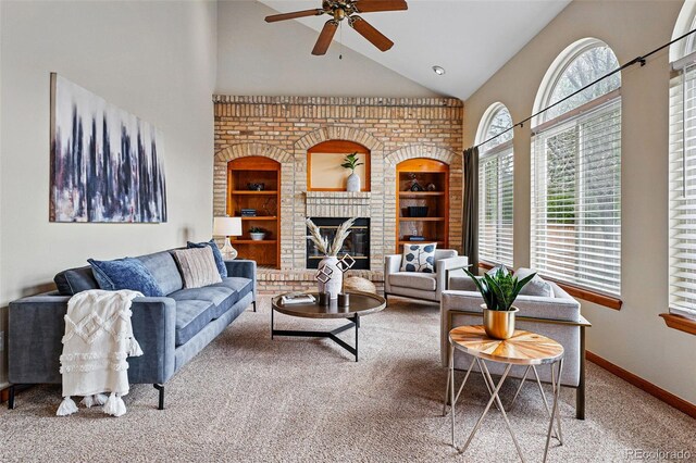 9515 Dolton Way, Highlands Ranch, CO 80126 - carpeted living room featuring ceiling fan, high vaulted ceiling, built in features, baseboards, and a brick fireplace