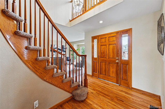 9515 Dolton Way, Highlands Ranch, CO 80126 - entryway with wood finished floors, baseboards, stairs, and recessed lighting