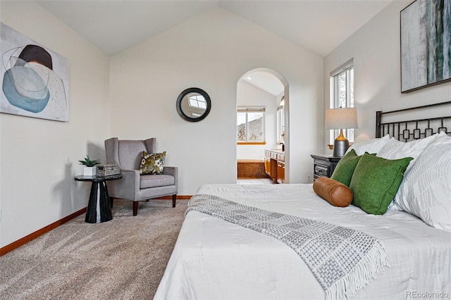 9515 Dolton Way, Highlands Ranch, CO 80126 - carpeted bedroom featuring lofted ceiling, arched walkways, baseboards, and connected bathroom