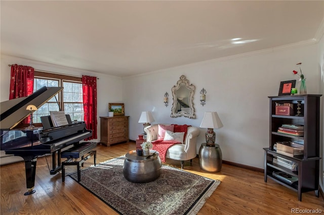 living area with hardwood / wood-style floors and ornamental molding