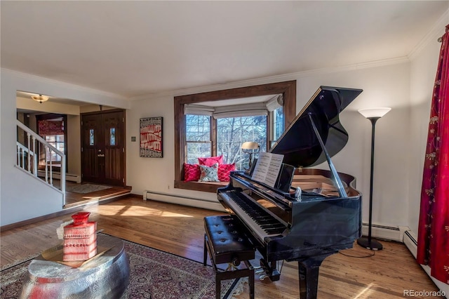 misc room with baseboard heating, hardwood / wood-style flooring, and crown molding