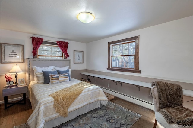 bedroom featuring dark hardwood / wood-style flooring and a baseboard radiator