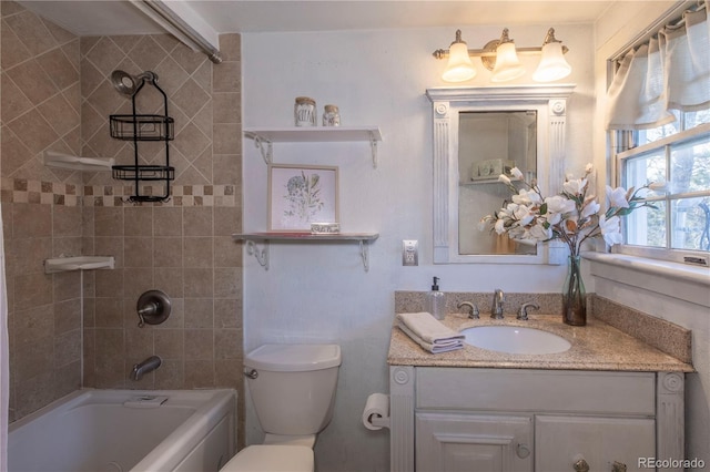 full bathroom featuring toilet, vanity, and tiled shower / bath combo