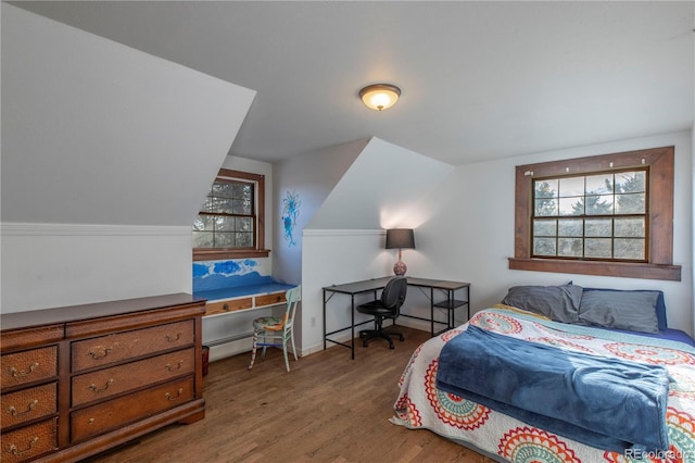 bedroom featuring vaulted ceiling and hardwood / wood-style flooring