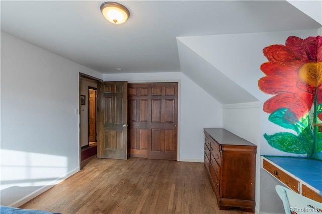 bonus room featuring lofted ceiling and hardwood / wood-style floors