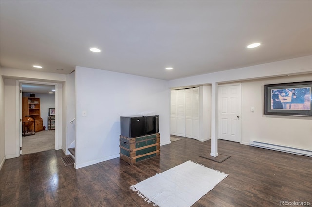 interior space featuring dark hardwood / wood-style flooring and a baseboard heating unit