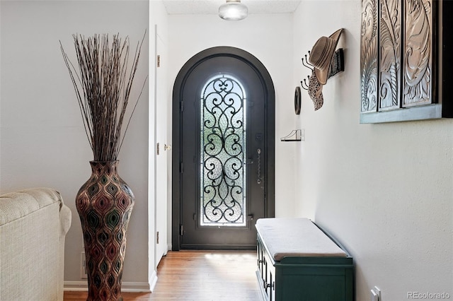 1332 Ash St, Denver, CO 80220 - foyer with arched walkways and light wood-style floors