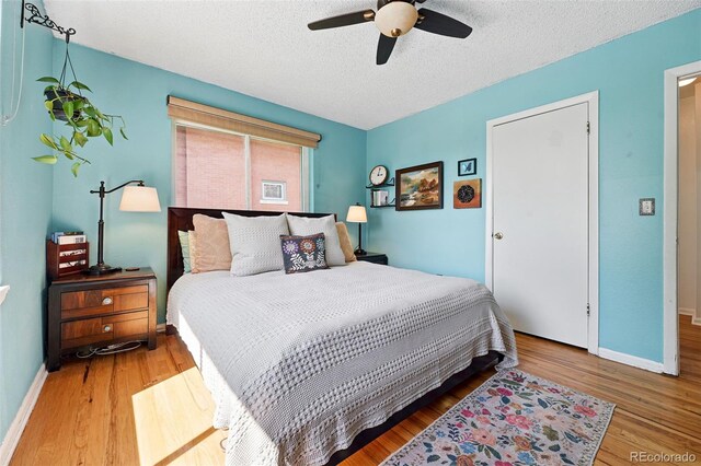 1332 Ash St, Denver, CO 80220 - bedroom featuring wood finished floors, a textured ceiling, and a ceiling fan