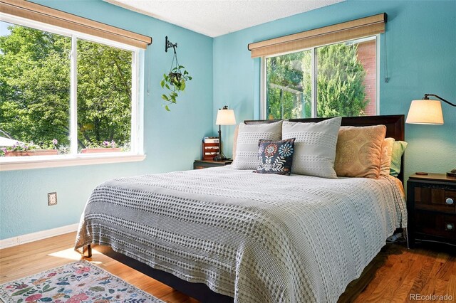 1332 Ash St, Denver, CO 80220 - bedroom with wood finished floors and baseboards