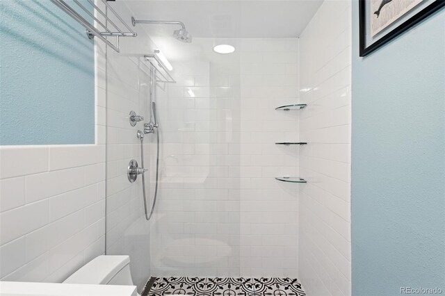 1332 Ash St, Denver, CO 80220 - full bathroom with tiled shower, tile walls, and wainscoting