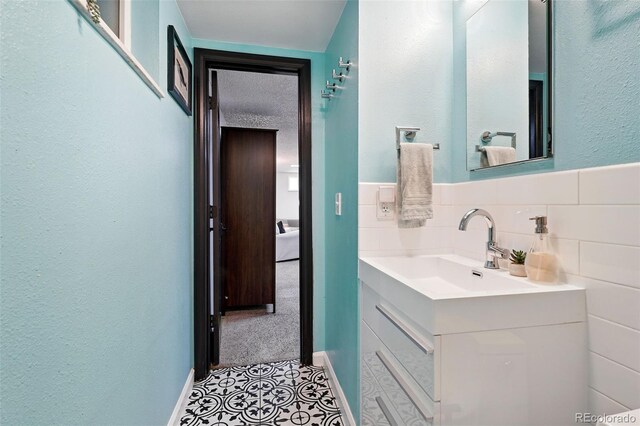 1332 Ash St, Denver, CO 80220 - bathroom featuring vanity, a textured wall, and tile patterned flooring