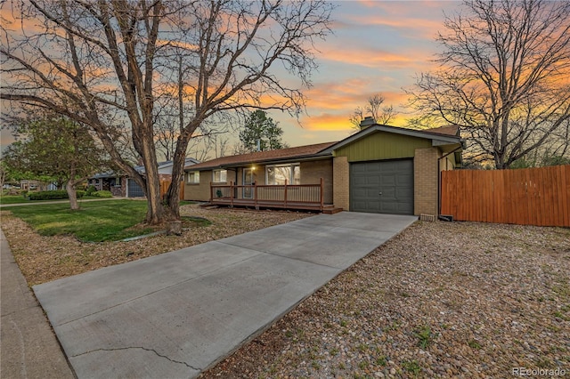 single story home with brick siding, a garage, a chimney, driveway, and covered porch