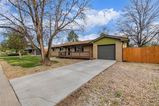 single story home featuring brick siding, an attached garage, driveway, a porch, and a chimney