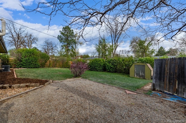 view of yard featuring a storage shed, an outdoor structure, a patio, and central AC unit