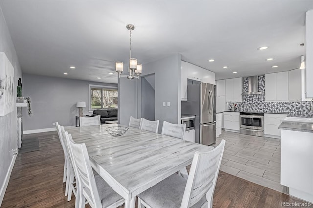 dining area featuring a chandelier, recessed lighting, wood finished floors, and baseboards