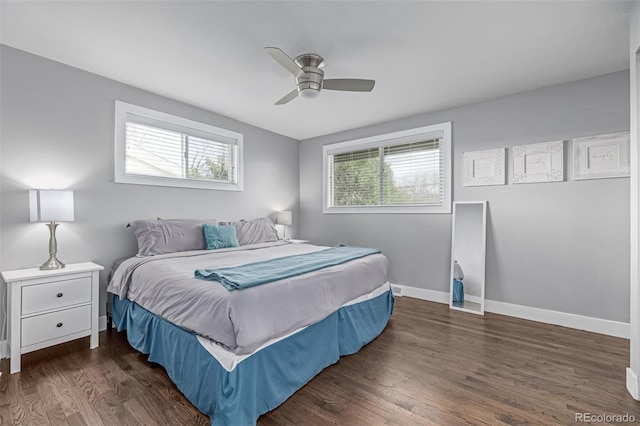 bedroom featuring multiple windows, wood finished floors, and baseboards