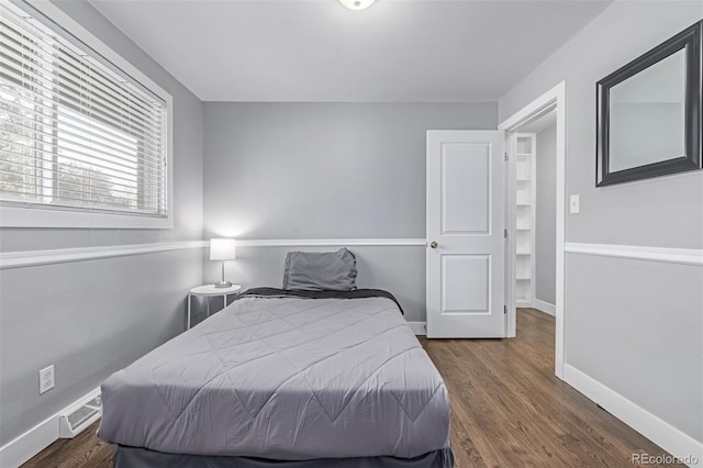 bedroom featuring dark wood finished floors and baseboards