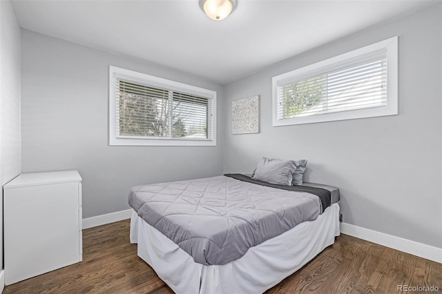 bedroom featuring baseboards and wood finished floors