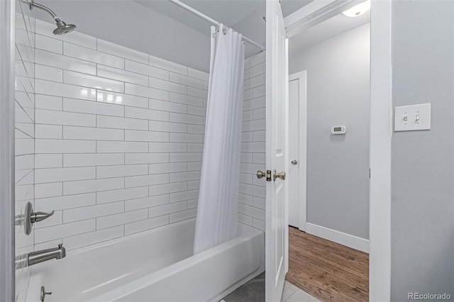 full bath with shower / bath combination with curtain and baseboards
