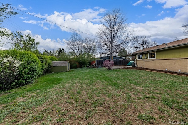 view of yard with a storage unit and an outbuilding