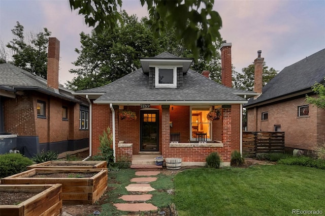 4430 Zuni St, Denver, CO 80211 - bungalow-style home with a garden, brick siding, a porch, a shingled roof, and a chimney