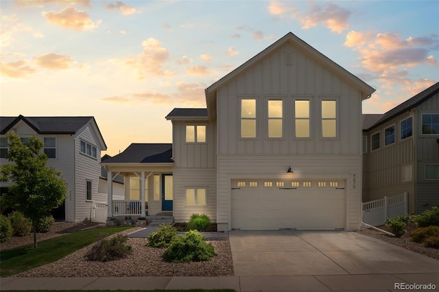 4670 Tanner Peak Trl, Brighton, CO 80601 - view of front of property featuring board and batten siding, a porch, a garage, and driveway