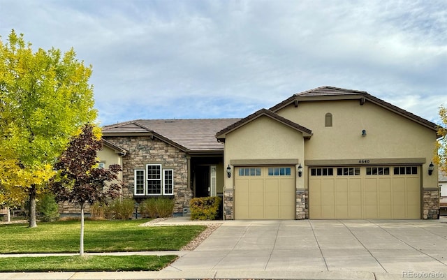 view of front of home with a front lawn and a garage