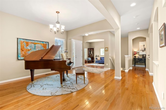 misc room with a notable chandelier and light hardwood / wood-style flooring