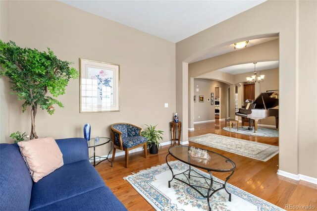 living room featuring light hardwood / wood-style floors and a chandelier