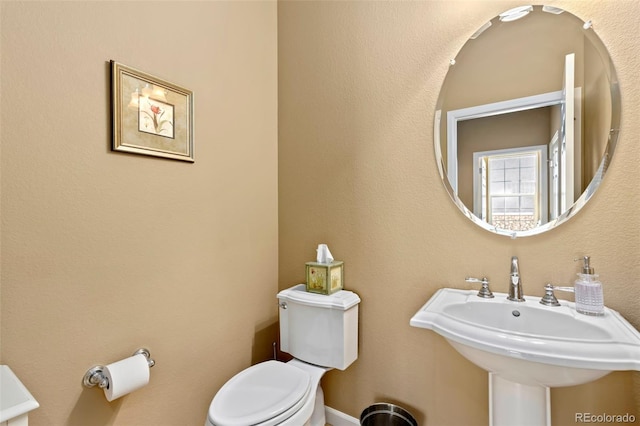 bathroom with toilet and sink