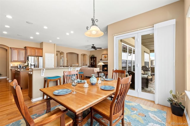 dining room featuring light hardwood / wood-style floors and ceiling fan