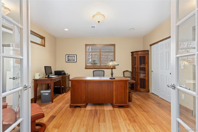 office space featuring french doors and light hardwood / wood-style floors