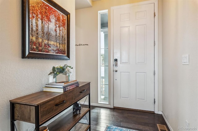 foyer with dark hardwood / wood-style floors